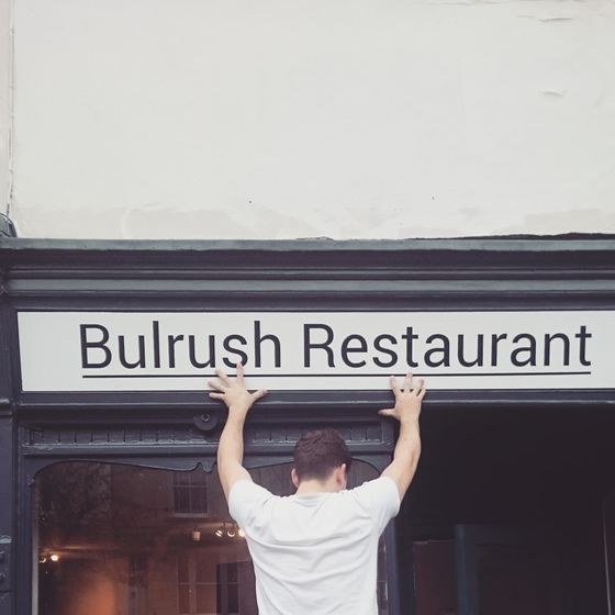 Hanging the Bulrush Restaurant sign above the shop