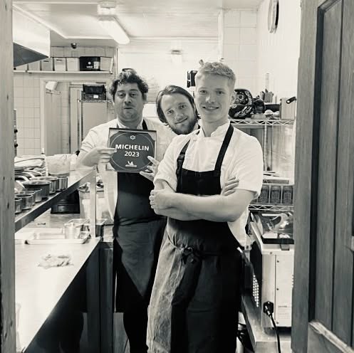 The Bulrush kitchen team holding their Michelin star plaque
